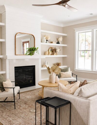 Elegant living room at 4 Harborview Circle featuring custom built-ins, a fireplace, and bright Lowcountry-inspired design