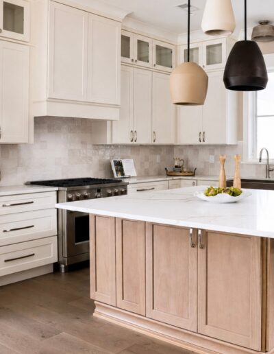 Custom kitchen at 4 Harborview Circle featuring a large island, quartz countertops, designer lighting, and custom cabinetry