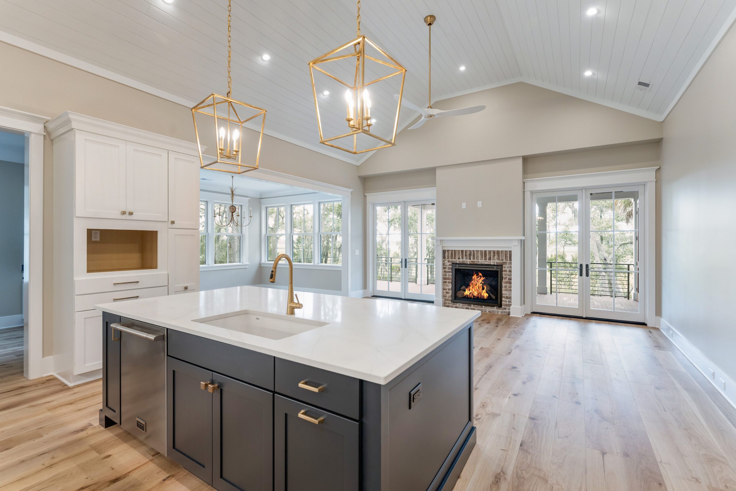 Home Facade with White Siding, Wooden Doors, and A Metal Roof by Allen Patterson Builders.