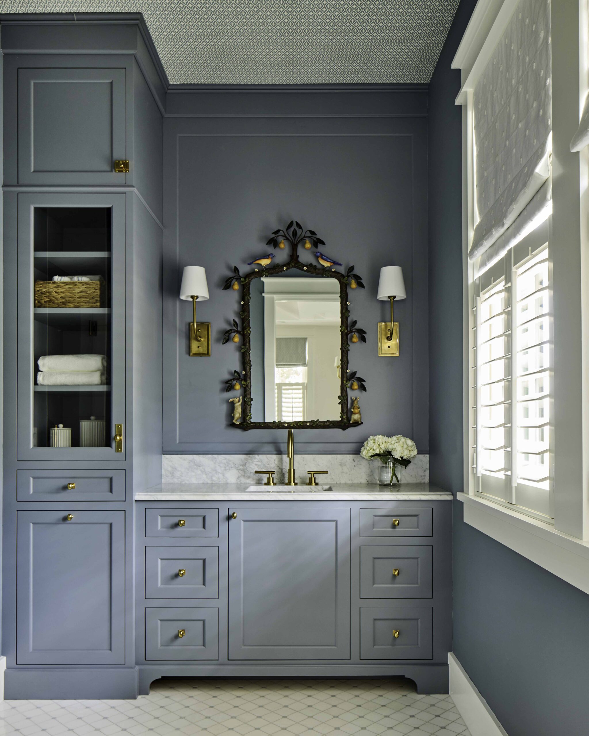 Bathroom with slate-blue cabinetry, marble counter, and brass fixtures in the 2025 Southern Living Showcase Home in Habersham, SC, built by Allen Patterson Builders