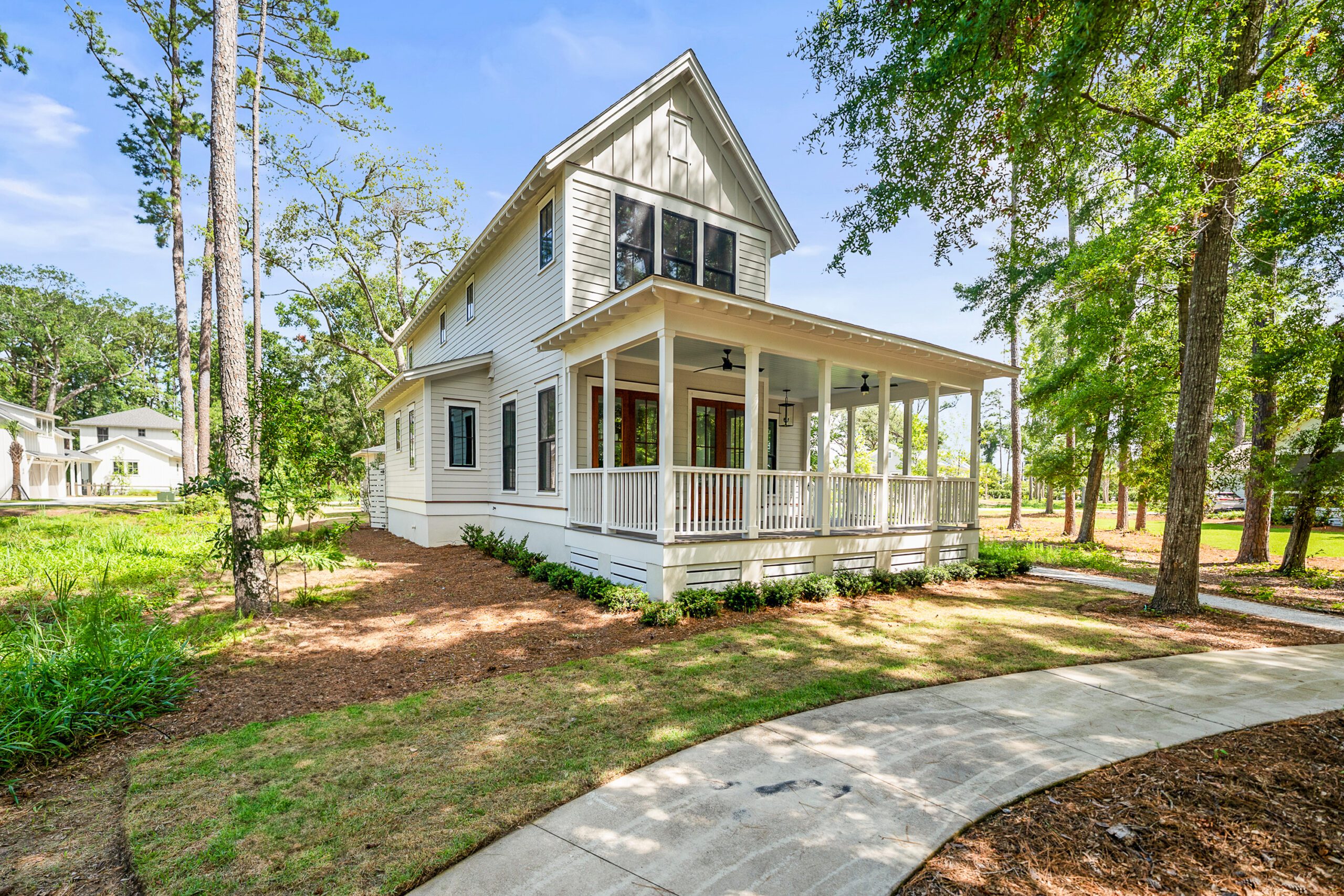 Exterior view of 209 Harborview Drive in Beaufort, SC featuring classic Lowcountry architecture, a wraparound porch, and mature trees.
