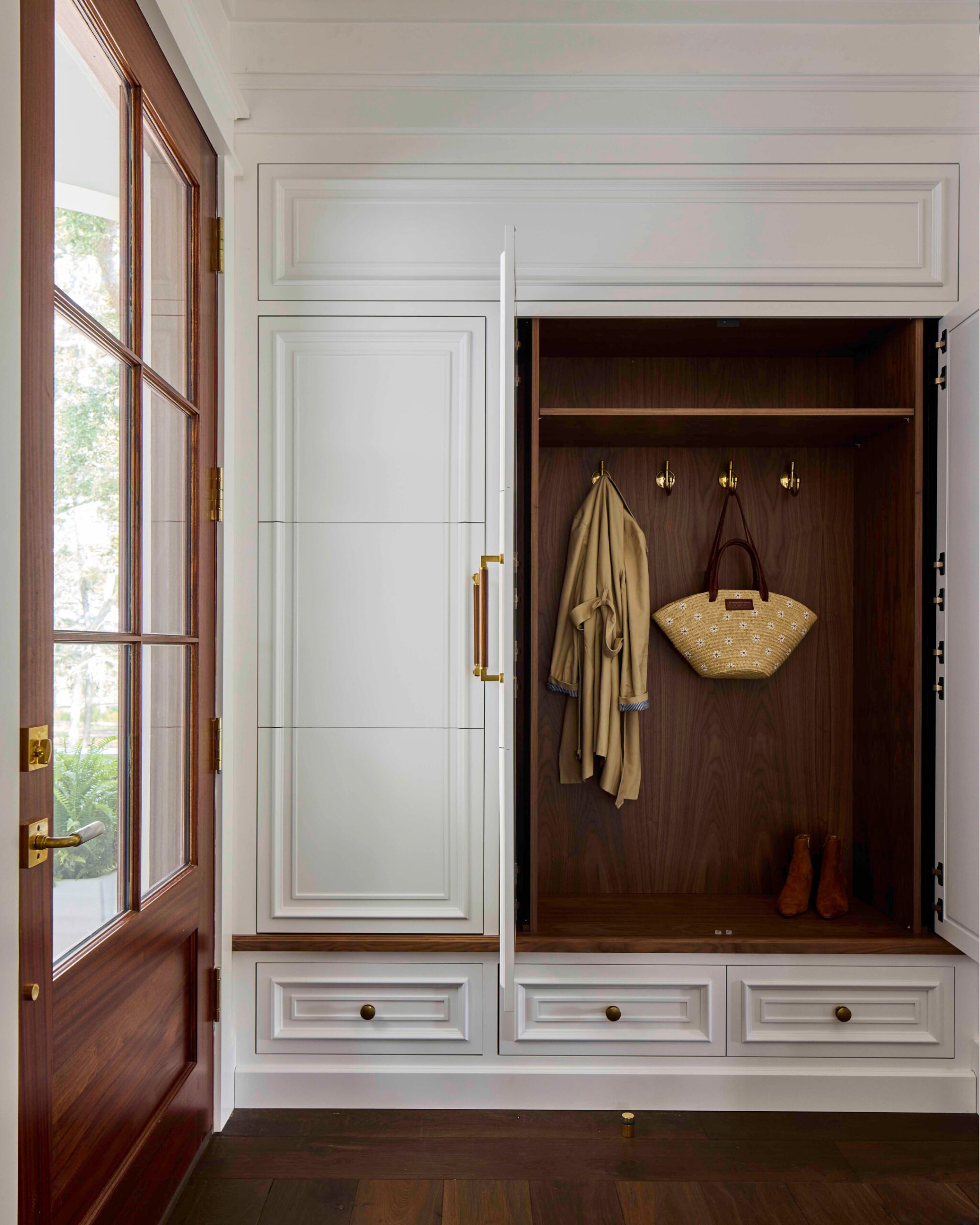 Mudroom with custom white built-in cabinetry and a walnut-lined interior in the 2025 Southern Living Showcase Home in Habersham, SC, built by Allen Patterson Builders
