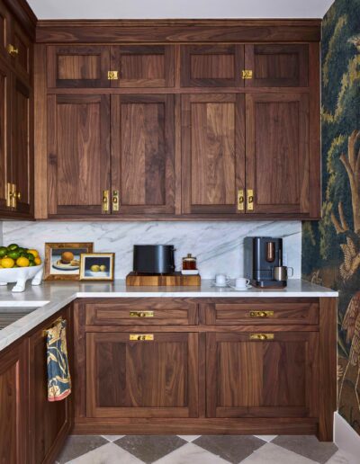 Walnut custom cabinetry and marble countertop in the Habersham Showcase Home kitchen, with a checkerboard tile floor, built by Allen Patterson Builders