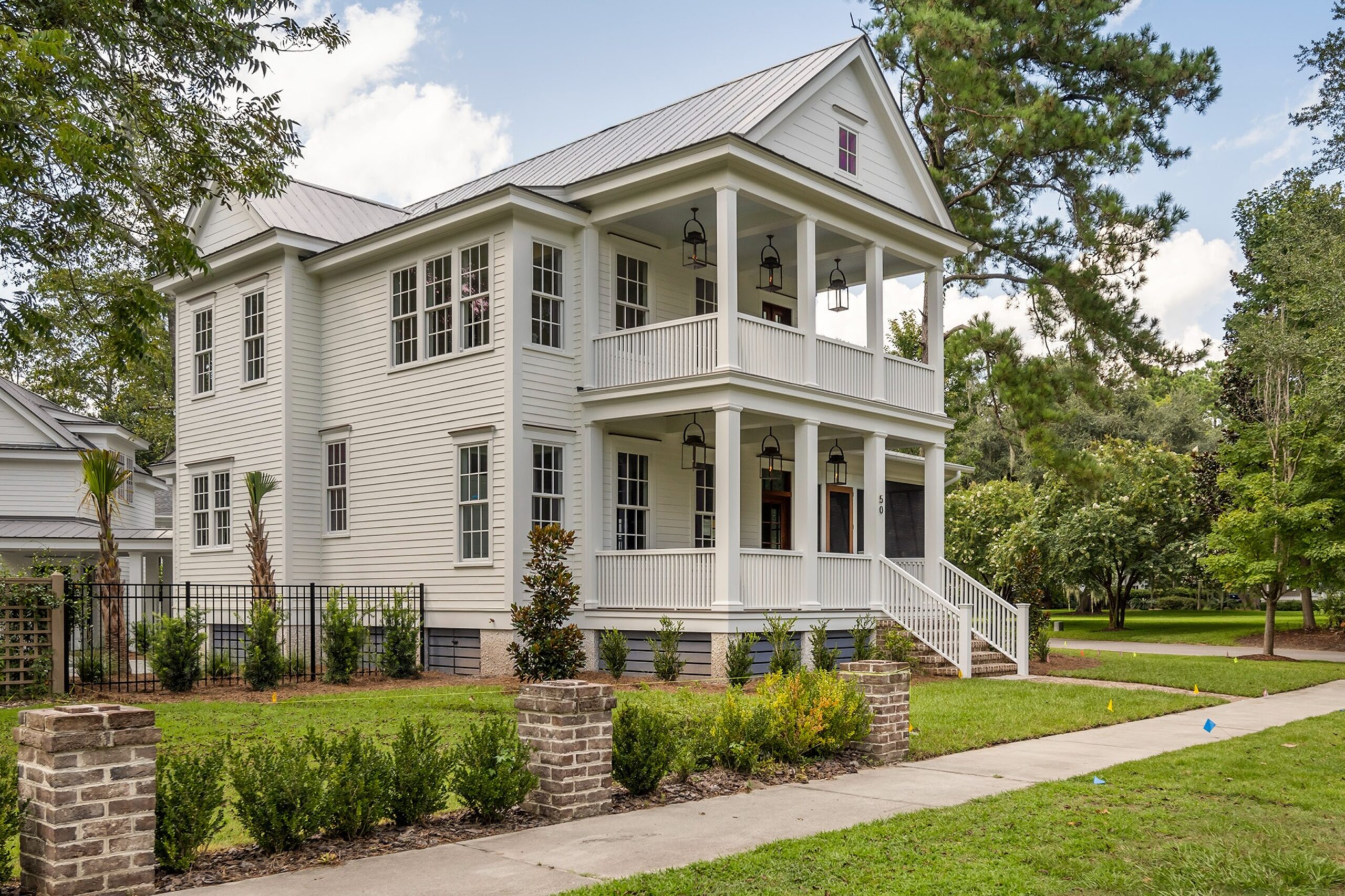 Luxury Lowcountry Home Poolside View with A Stone Patio and Serene Landscape.