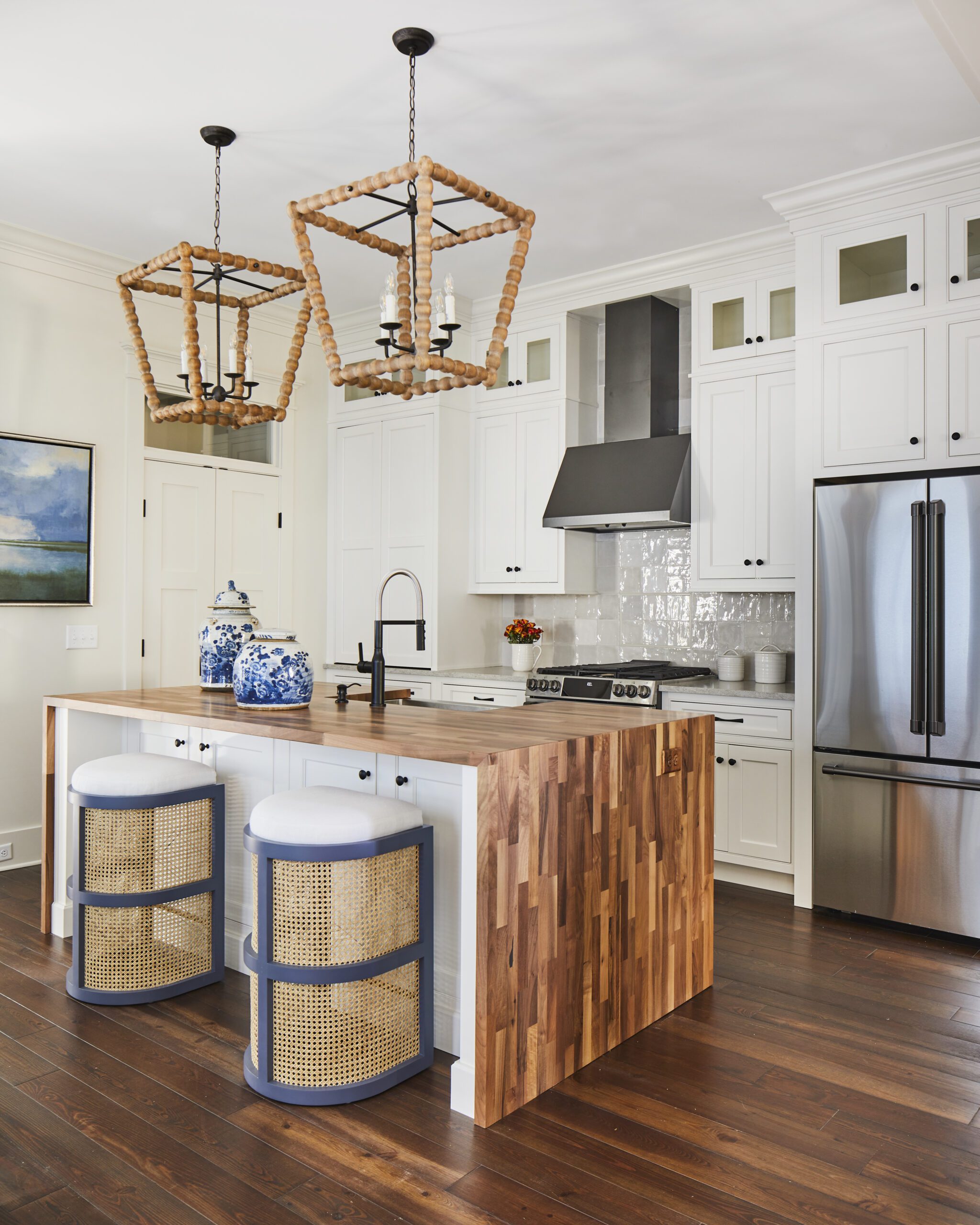 Kitchen with a wood waterfall island and bead chandeliers in the 2020 Southern Living Showcase Home in Habersham, SC.